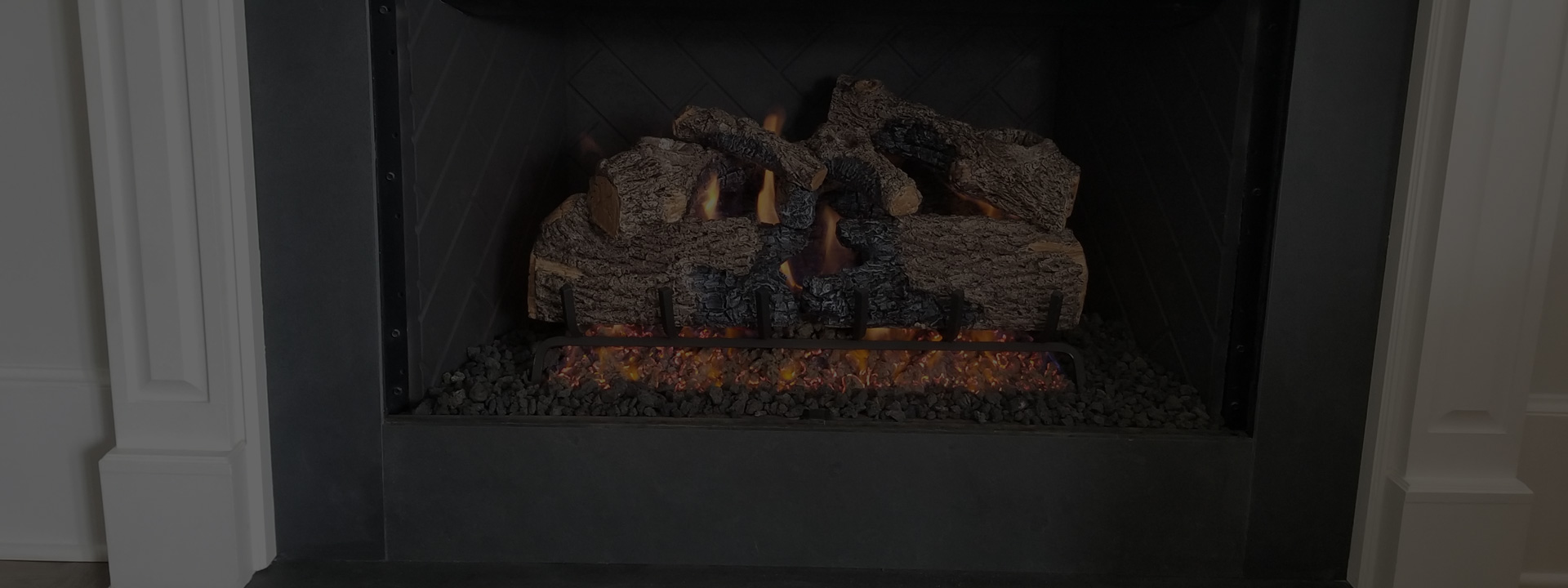 A fireplace with logs in it.